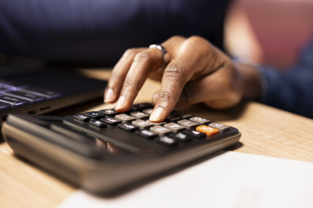 female using a calculator to track expenses.